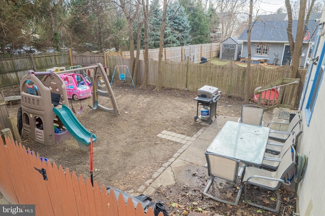 view of jungle gym featuring a storage shed