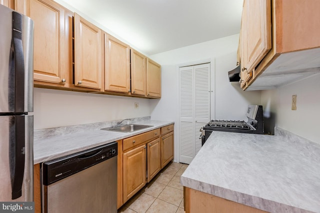 kitchen featuring light tile patterned flooring, appliances with stainless steel finishes, sink, and light brown cabinets