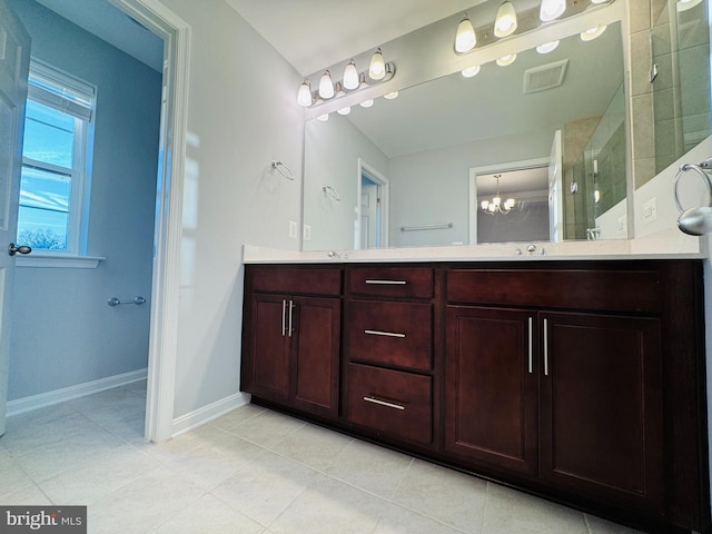 bathroom featuring vanity, a shower with shower door, and a chandelier