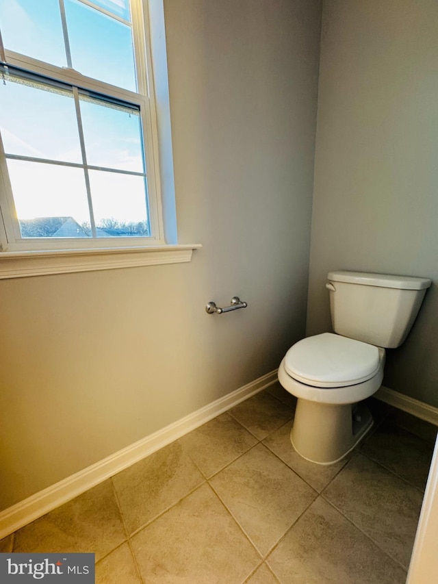 bathroom featuring tile patterned floors, toilet, and a mountain view