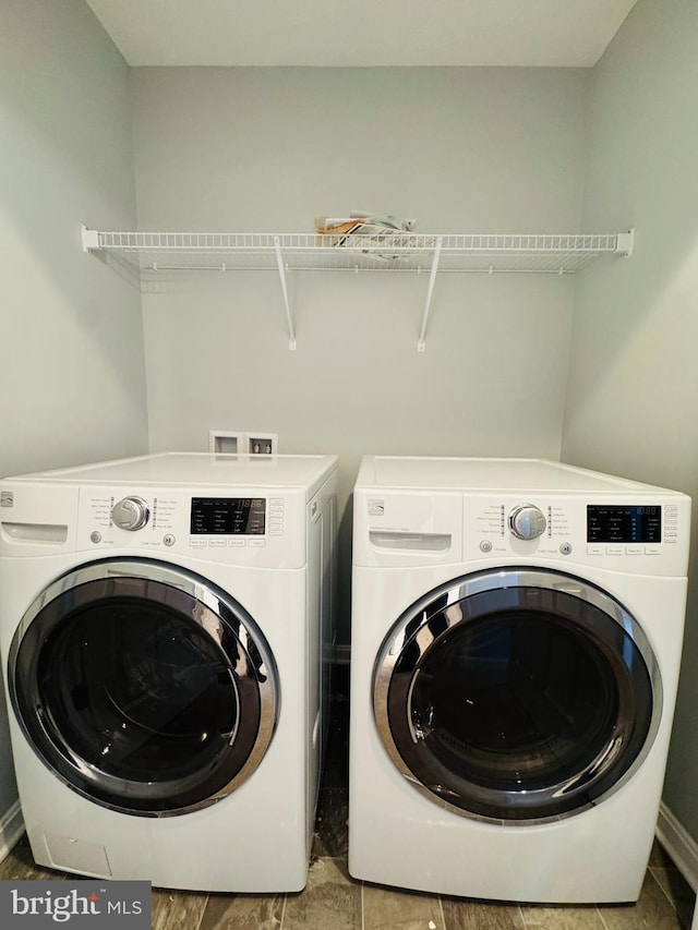 laundry area featuring washer and clothes dryer and tile patterned floors