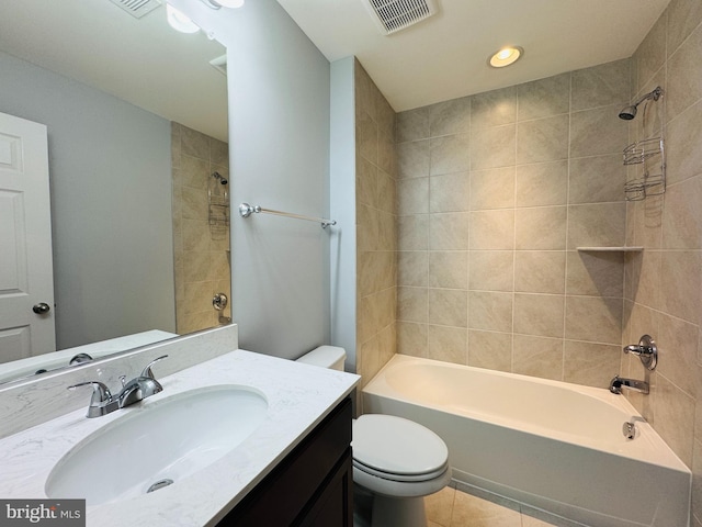 full bathroom with vanity, tiled shower / bath, tile patterned floors, and toilet