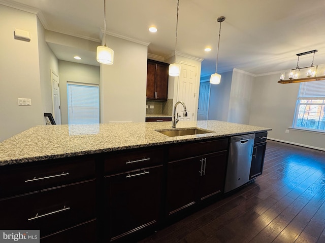 kitchen featuring pendant lighting, an island with sink, dishwasher, and sink