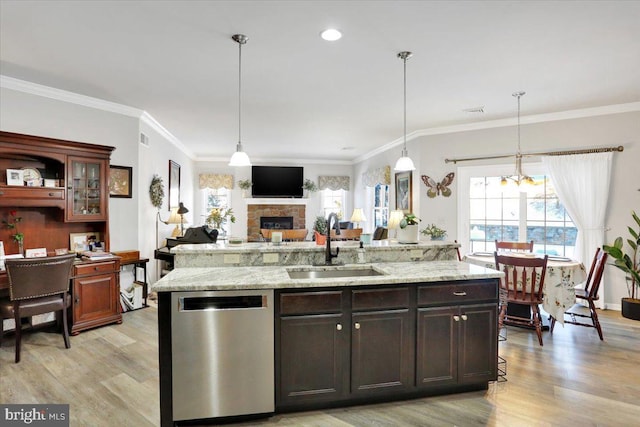 kitchen with decorative light fixtures, dishwasher, light hardwood / wood-style flooring, dark brown cabinetry, and sink