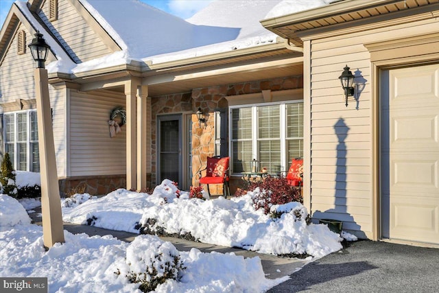 view of snow covered property entrance