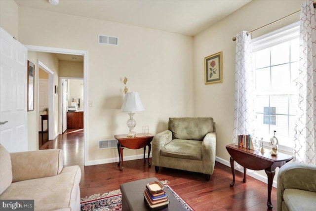 sitting room featuring dark hardwood / wood-style flooring