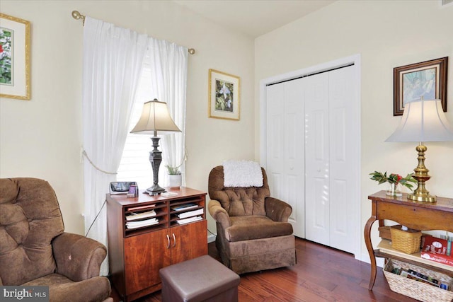 sitting room featuring a wealth of natural light and dark hardwood / wood-style floors