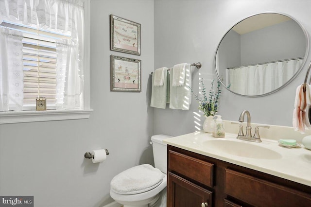 bathroom featuring toilet and vanity