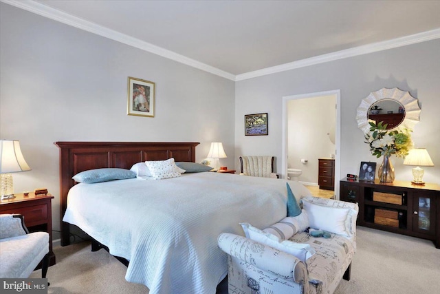 bedroom featuring light colored carpet, crown molding, and ensuite bath