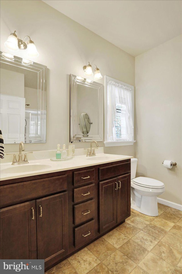 bathroom with toilet and vanity