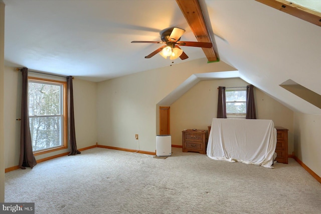 additional living space featuring lofted ceiling with beams, light colored carpet, and ceiling fan