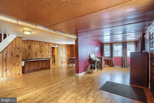 interior space featuring wooden walls and light hardwood / wood-style flooring