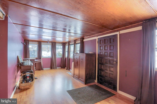 foyer featuring light hardwood / wood-style floors and wooden ceiling