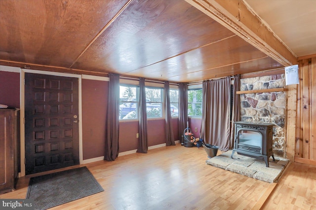 interior space featuring wood ceiling and a wood stove