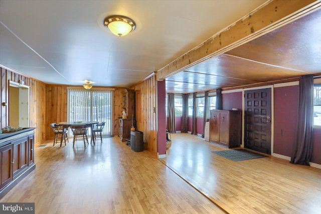 interior space featuring light hardwood / wood-style floors, a healthy amount of sunlight, and wood walls