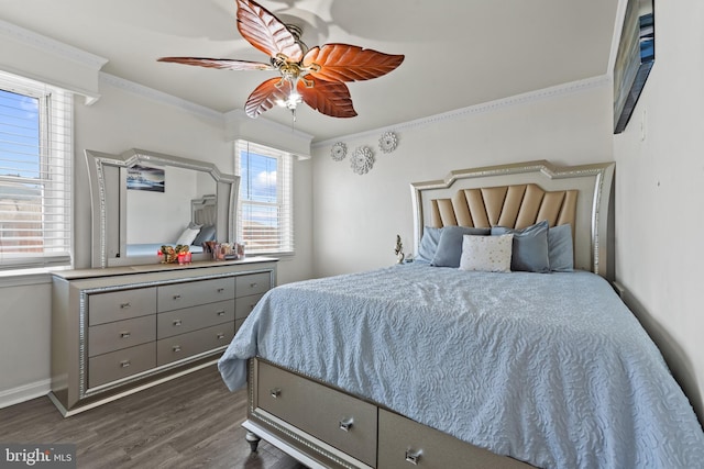 bedroom with ceiling fan, crown molding, and dark hardwood / wood-style flooring