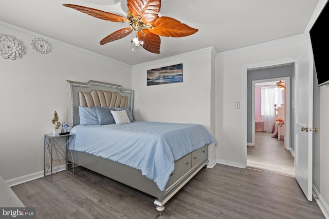 bedroom featuring ceiling fan, hardwood / wood-style flooring, and crown molding