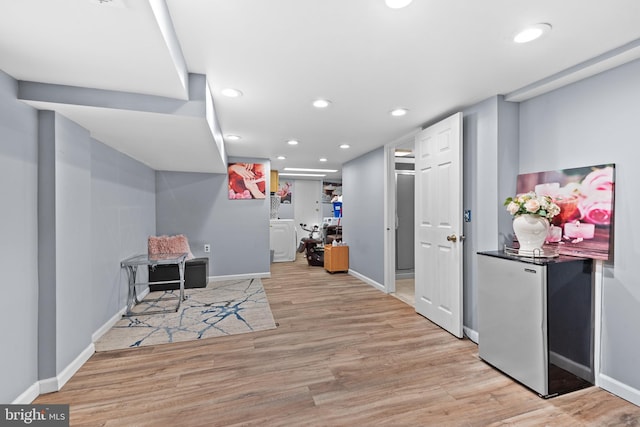 interior space with washer / clothes dryer and light wood-type flooring