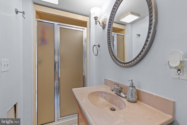 bathroom with an enclosed shower and vanity