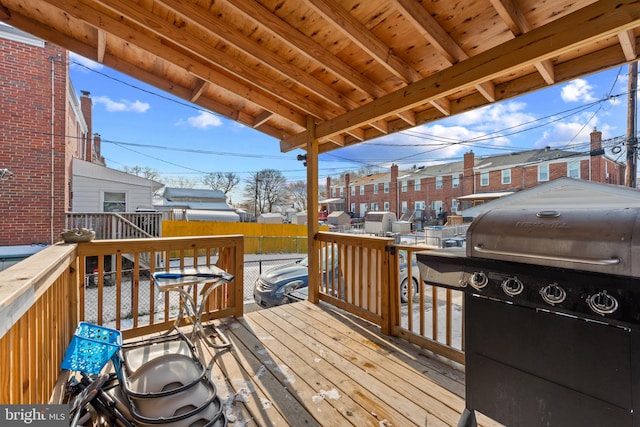 wooden terrace featuring a grill