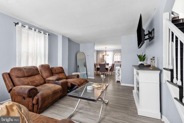 living room with hardwood / wood-style flooring and a chandelier