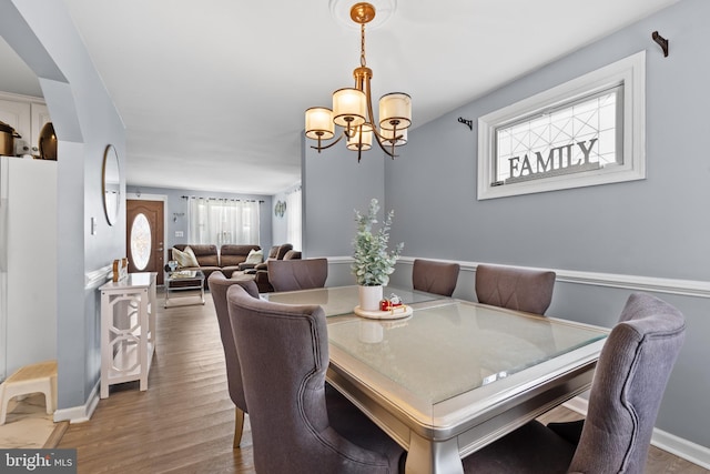 dining room featuring hardwood / wood-style flooring and a notable chandelier