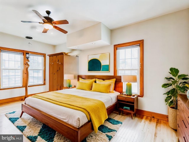 bedroom with light hardwood / wood-style flooring and ceiling fan