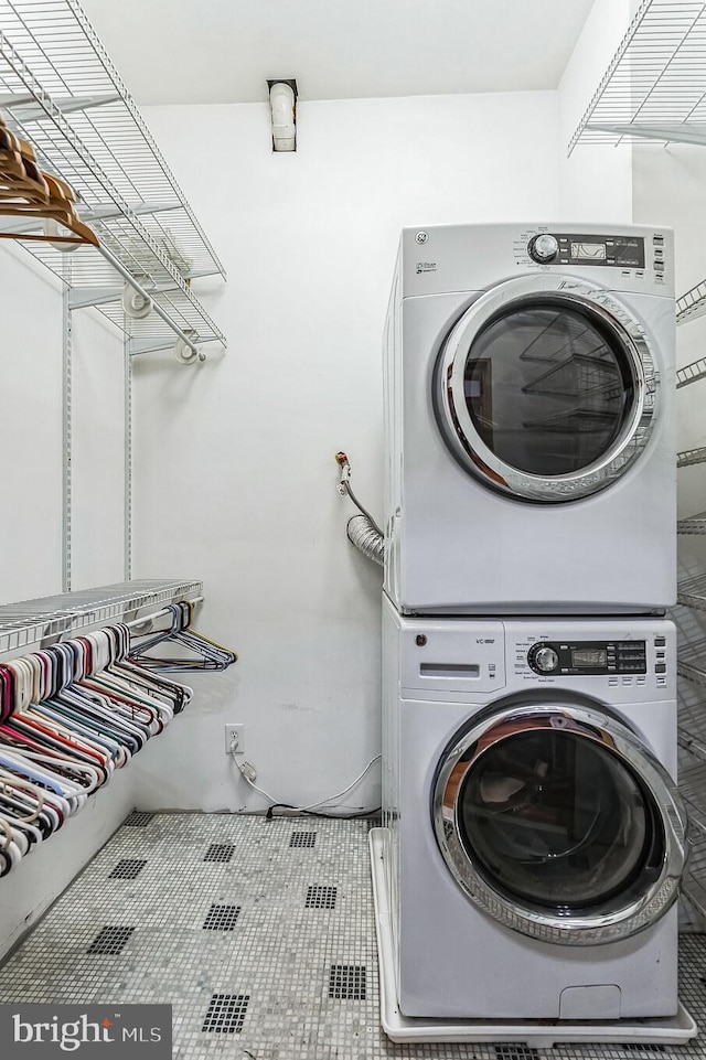 laundry area featuring stacked washer and clothes dryer