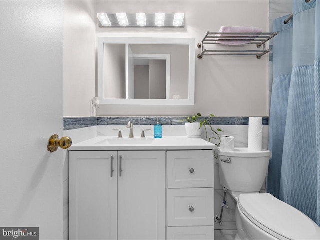 bathroom featuring toilet, walk in shower, backsplash, and vanity