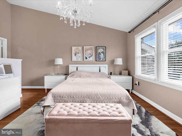 bedroom with vaulted ceiling, dark hardwood / wood-style flooring, and a notable chandelier