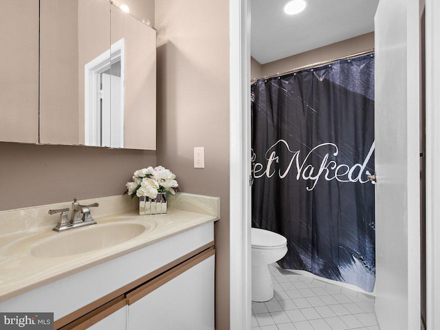 bathroom featuring toilet, vanity, and tile patterned flooring