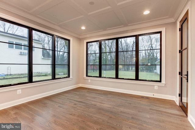 unfurnished sunroom featuring plenty of natural light, visible vents, and coffered ceiling