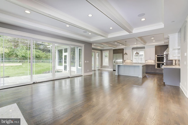 unfurnished living room featuring baseboards, ornamental molding, dark wood-type flooring, beamed ceiling, and recessed lighting