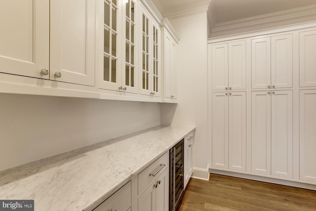 bar with wine cooler, dark wood-type flooring, and crown molding