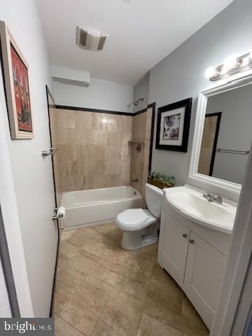 full bathroom featuring vanity, tiled shower / bath, and toilet