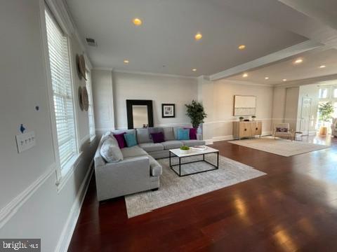 living room with recessed lighting, wood finished floors, visible vents, baseboards, and ornamental molding