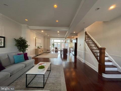 living room with crown molding and dark hardwood / wood-style floors