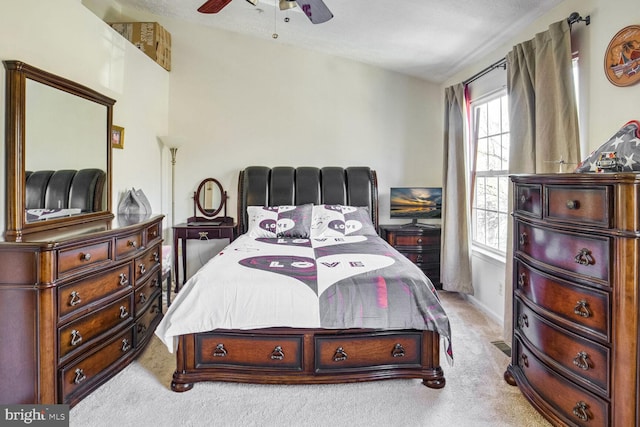 bedroom with vaulted ceiling, light carpet, and ceiling fan