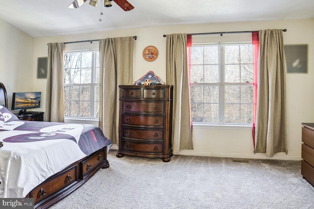 carpeted bedroom with ceiling fan