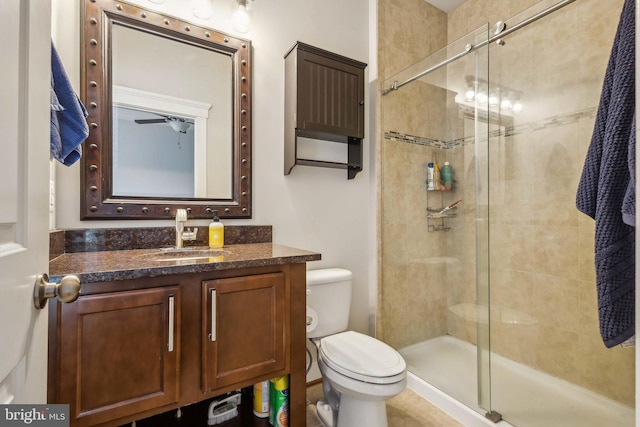 bathroom with walk in shower, vanity, and toilet