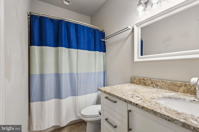 bathroom featuring tile patterned flooring, vanity, and toilet