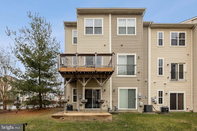 rear view of house featuring a lawn, a patio, and central air condition unit