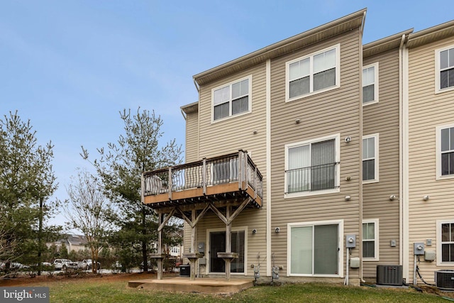 back of property featuring a yard, central AC unit, and a patio area