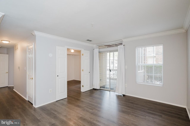 empty room with ornamental molding and dark wood-type flooring