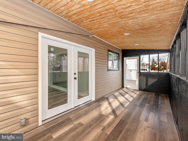 unfurnished sunroom with wooden ceiling, lofted ceiling, and french doors