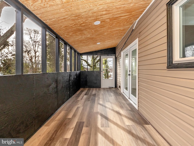 unfurnished sunroom featuring wooden ceiling, lofted ceiling, and french doors