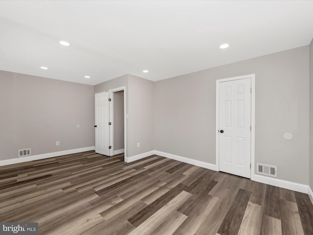 spare room with dark wood-type flooring