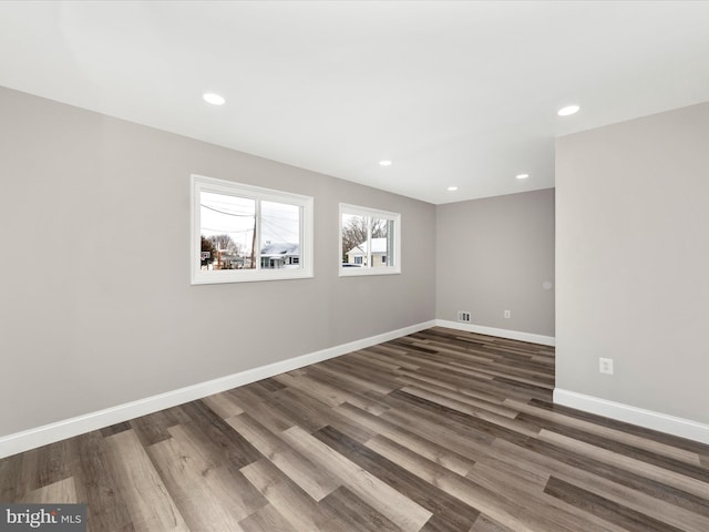 spare room featuring dark hardwood / wood-style floors