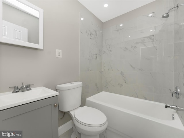 full bathroom featuring toilet, tiled shower / bath combo, and vanity