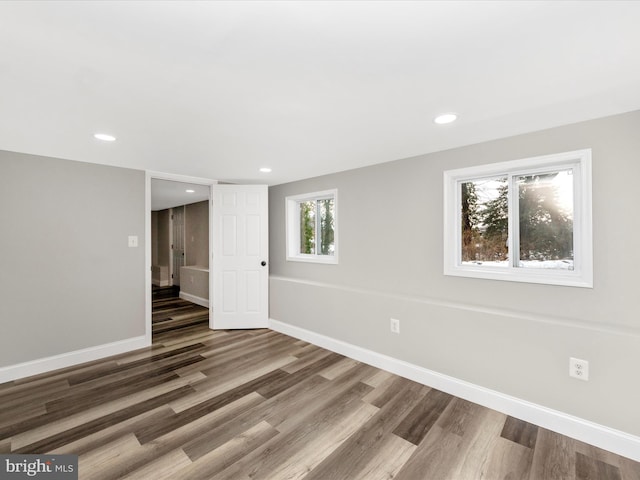 unfurnished room with dark hardwood / wood-style flooring